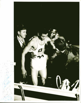 Rafer Johnson helping UCLA teammate CK Yang at the end of a race